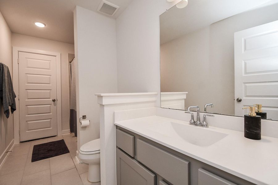 A generous secondary bath delivers the same creature comforts of its primary, with combined shower/bathtub, seen up right in this view. A generous secondary bath delivers the same creature comforts of its primary, with combined shower/bathtub, seen up right in this view.
