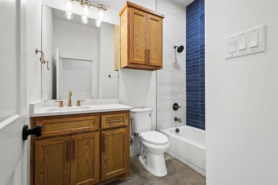 Full hallway bathroom with shower / bathtub combination and vanity