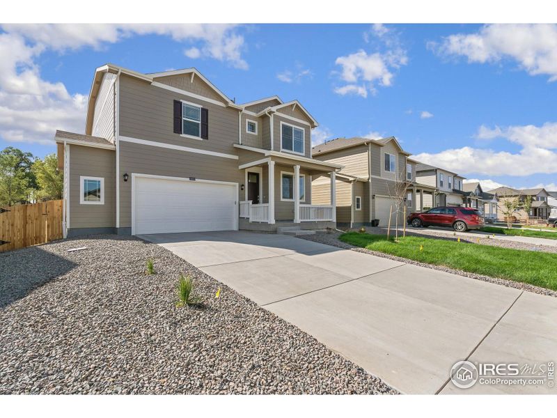 Front exterior of a new home in Brighton Crossing, Brighton, CO, highlighting curb appeal (Image 18).