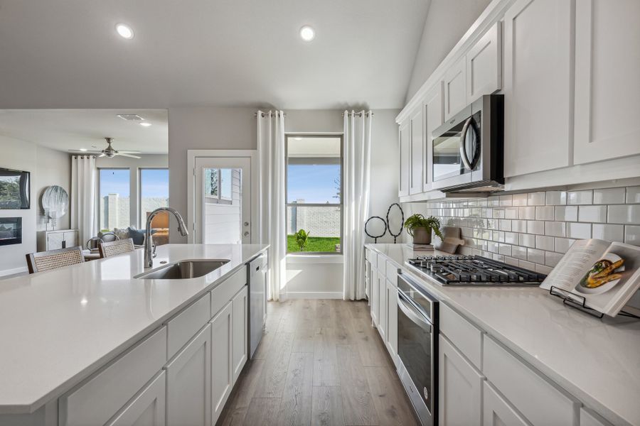 Kitchen in the Wimbledon home plan by Trophy Signature Homes – REPRESENTATIVE PHOTO