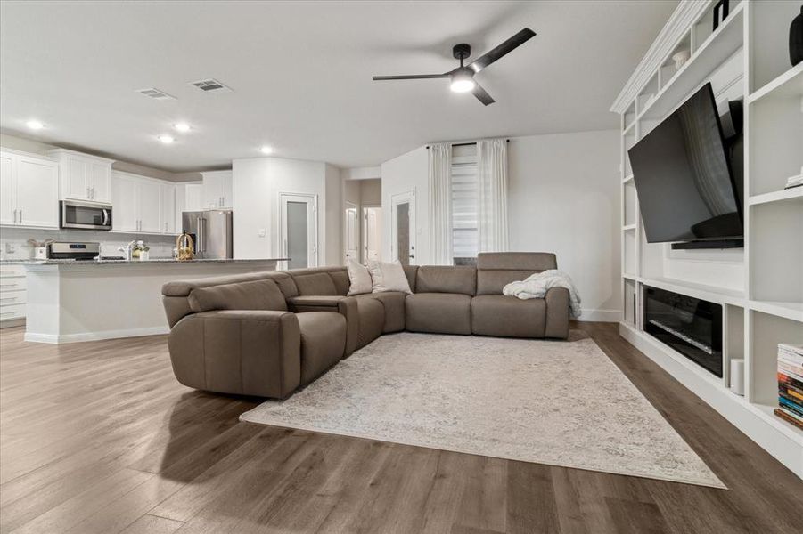 Living room featuring light wood-style floors, recessed lighting, and a ceiling fan Living room featuring light wood-style floors, recessed lighting, and a ceiling fan