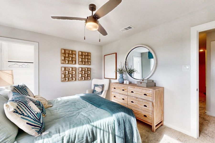 A bedroom with a large mirror.