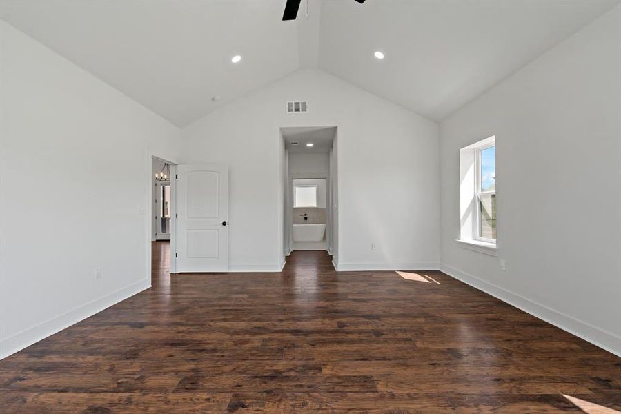 vaulted Ceilings, wood flooring, and ceiing fan