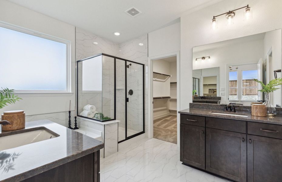 Owner's bath with separate vanities