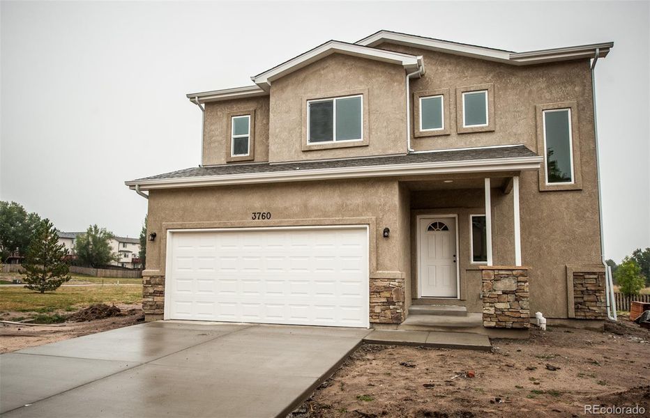 Front exterior of a new home in , Colorado Springs, CO, highlighting curb appeal (Image 19).