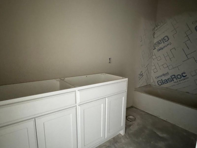 White vanity cabinetry with shaker-style doors