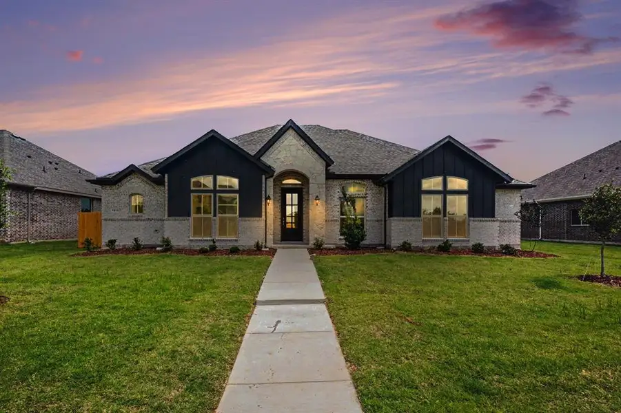 Front exterior of a new home in Ten Mile Creek Estates, DeSoto, TX, highlighting curb appeal (Image 19). Front exterior of a new home in Ten Mile Creek Estates, DeSoto, TX, highlighting curb appeal (Image 19).