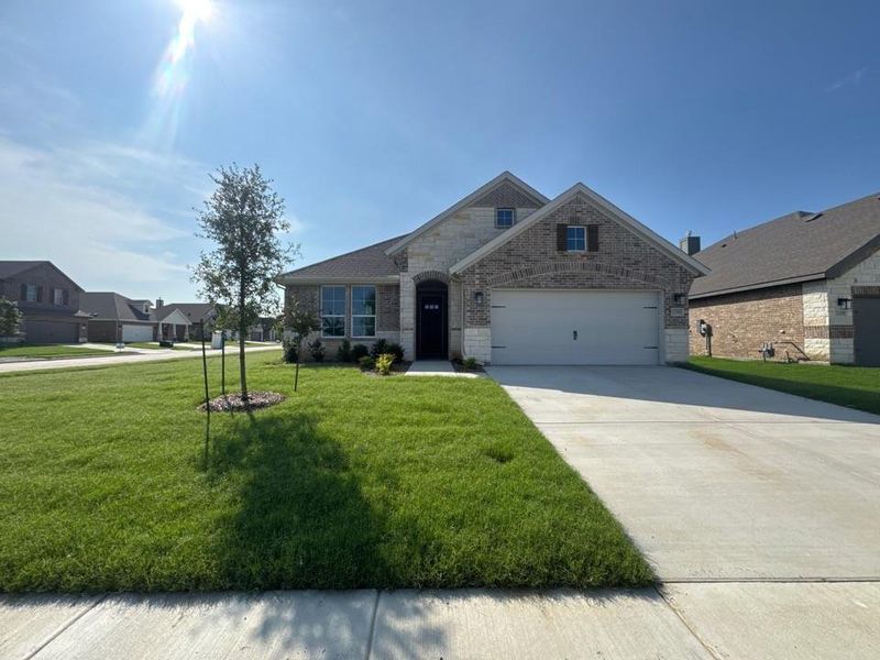 Front exterior of a new home in Cedar Ridge Estates, Anna, TX, highlighting curb appeal (Image 2). Front exterior of a new home in Cedar Ridge Estates, Anna, TX, highlighting curb appeal (Image 2).