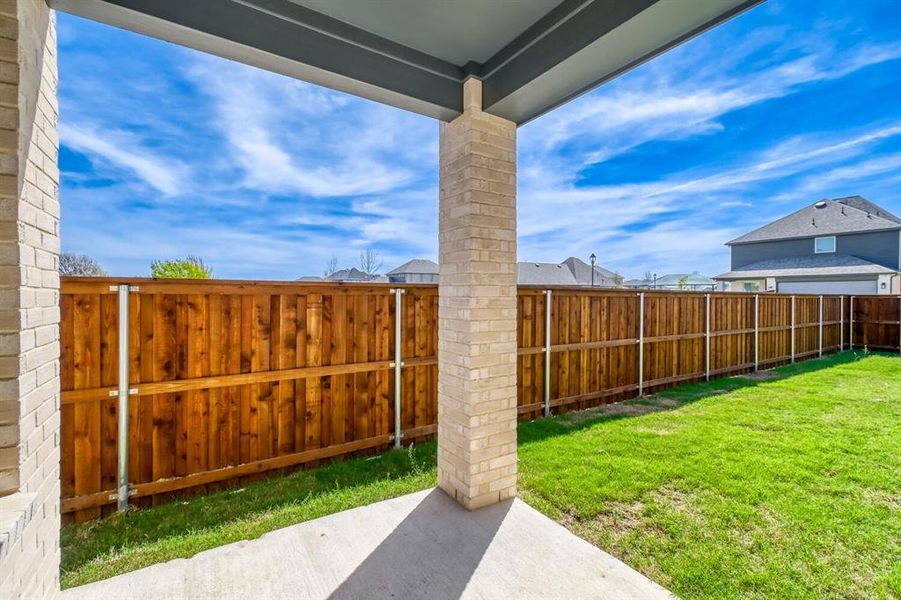 Fenced backyard with a patio area