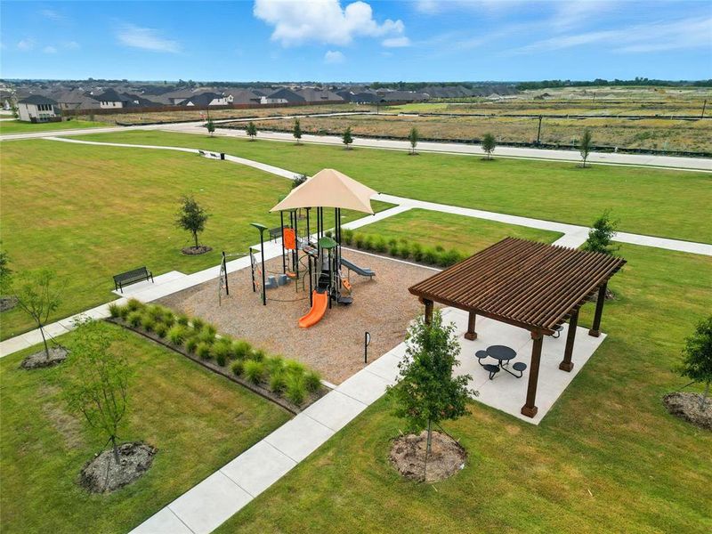 Communal playground with a lawn and a patio area