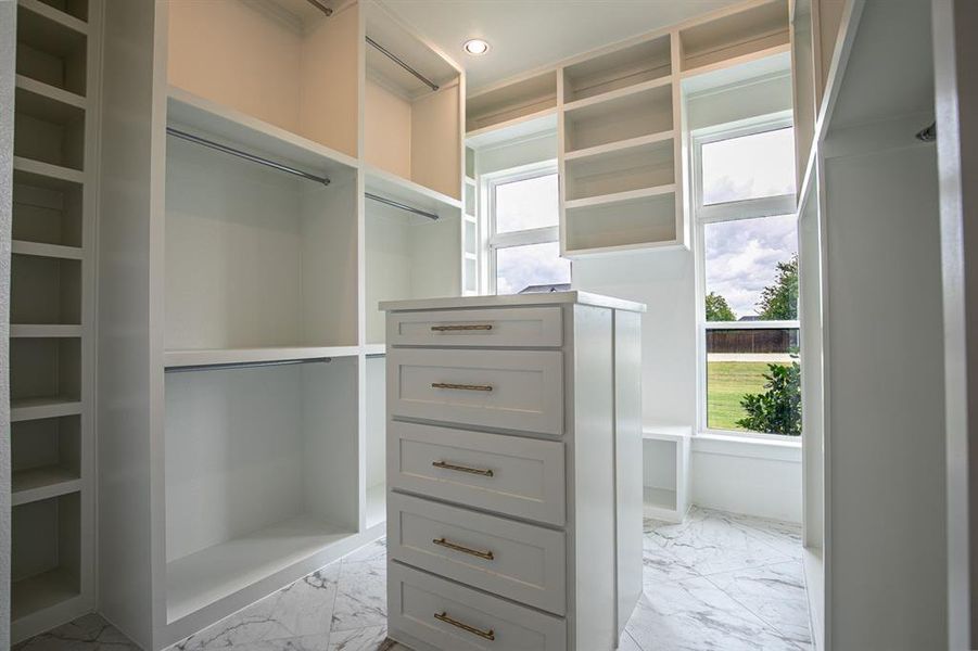 Closet #1 in primary bedroom with double sided dressers