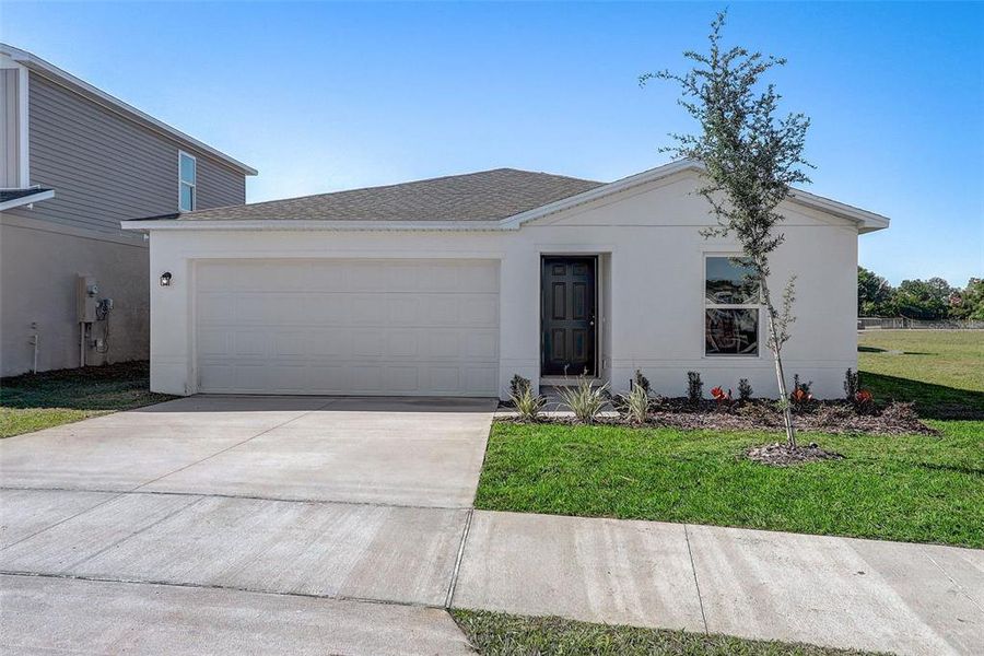 Front exterior of a new home in Lakewood Park, Fort Pierce, FL, highlighting curb appeal (Image 18). Front exterior of a new home in Lakewood Park, Fort Pierce, FL, highlighting curb appeal (Image 18).