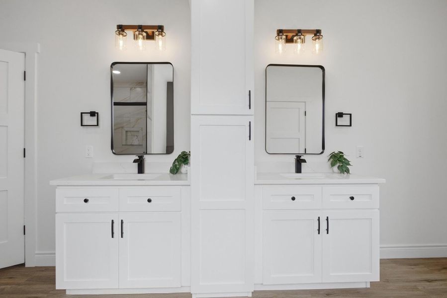 Luxurious primary bath with dual vanities and clean, refined finishes.