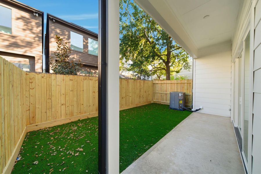 View of large private backyard, perfect for entertaining. (Photos are of a previously completed home with upgraded artificial turf. Finishes are subject to change.)