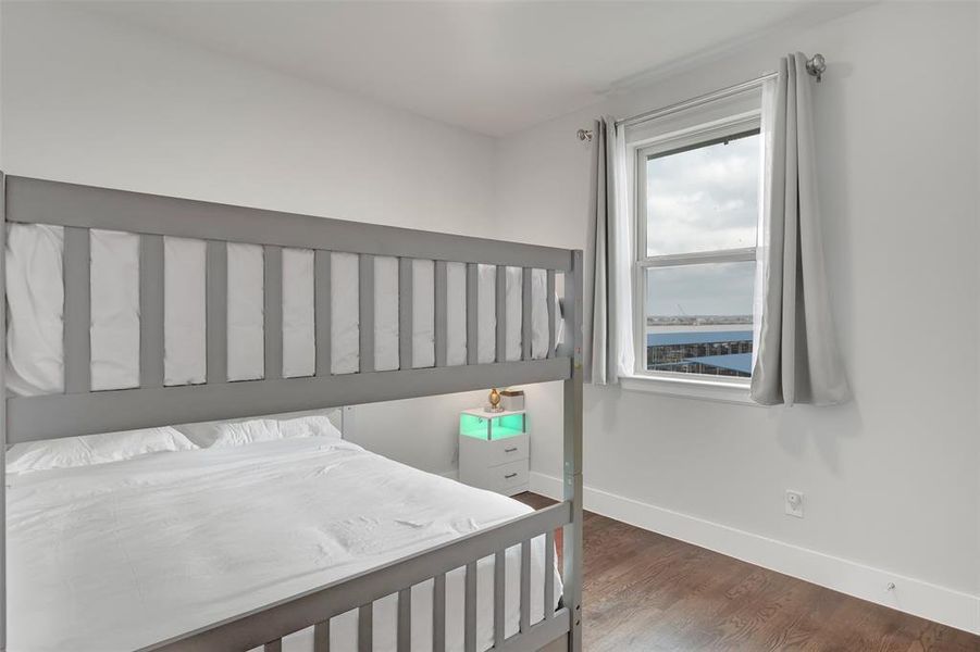 Bedroom featuring baseboards and wood finished floors