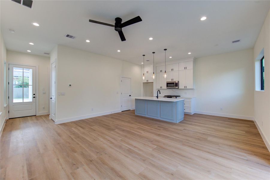Modern open-concept kitchen seamlessly connects to the living and spacious breakfast areas. Modern open-concept kitchen seamlessly connects to the living and spacious breakfast areas.