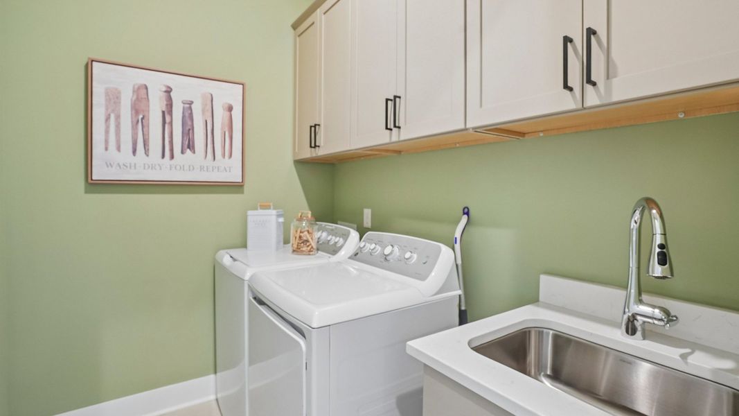 Dedicated laundry room with cabinets and sink Dedicated laundry room with cabinets and sink