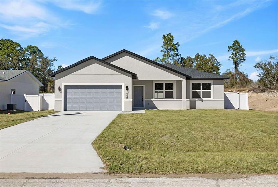 Front exterior of a new home in , Poinciana, FL, highlighting curb appeal (Image 1). Front exterior of a new home in , Poinciana, FL, highlighting curb appeal (Image 1).