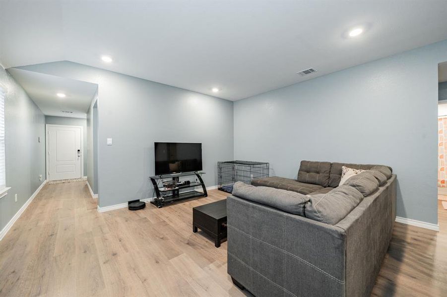 Living room featuring light wood-type flooring and recessed lighting Living room featuring light wood-type flooring and recessed lighting