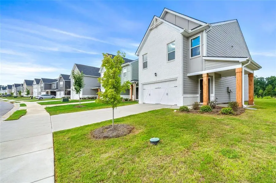 Front exterior of a new home in Crossvine Village, LaGrange, GA, highlighting curb appeal (Image 2). Front exterior of a new home in Crossvine Village, LaGrange, GA, highlighting curb appeal (Image 2).