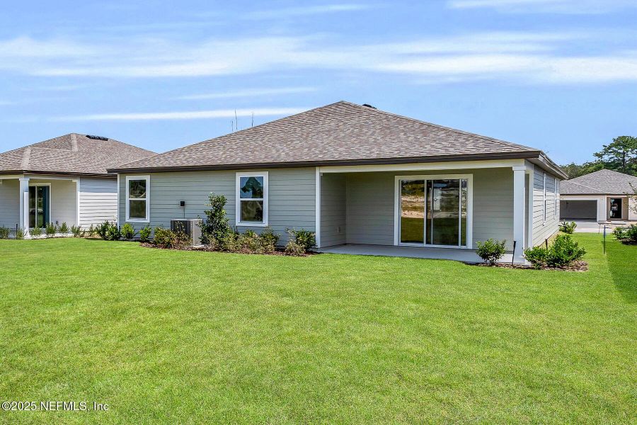 Front exterior of a new home in Whisper Ridge, Hilliard, FL, highlighting curb appeal (Image 14).