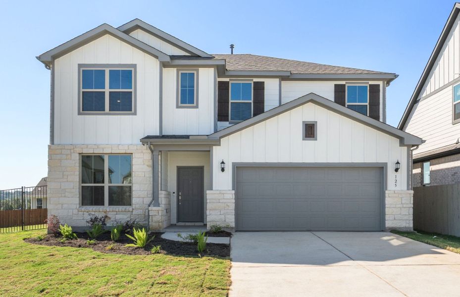 Front exterior of a new home in Saddleback at Santa Rita Ranch, Liberty Hill, TX, highlighting curb appeal (Image 27). Front exterior of a new home in Saddleback at Santa Rita Ranch, Liberty Hill, TX, highlighting curb appeal (Image 27).