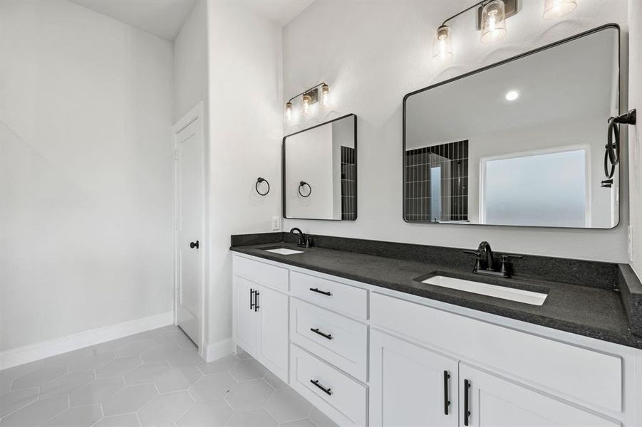 Bathroom featuring light tile patterned floors and double vanity