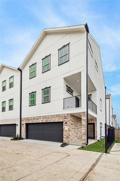 Modern exterior with sleek lines, spacious garage, and a welcoming balcony for outdoor relaxation.