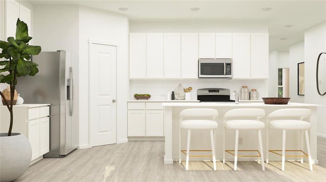 Kitchen featuring tasteful backsplash, appliances with stainless steel finishes, white cabinets, and a kitchen breakfast bar