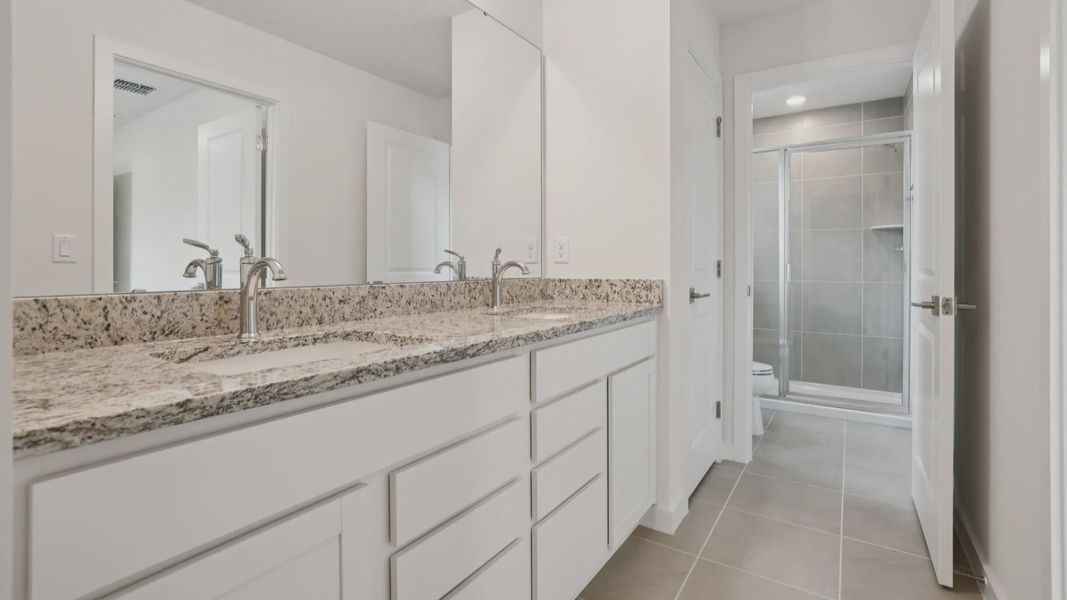 Dual Sinks in the primary bath of the Coronado - End at Cyrene at Harmony located in St Cloud FL by DRB Homes