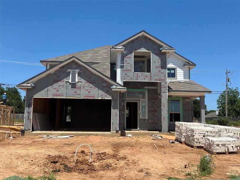 Property in mid-construction featuring an attached garage