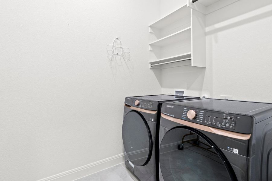 A dedicated laundry space with built-in shelving to keep all your supplies organized.