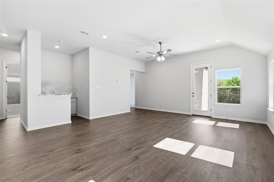 Unfurnished living room with recessed lighting, a ceiling fan, and dark wood-style floors Unfurnished living room with recessed lighting, a ceiling fan, and dark wood-style floors