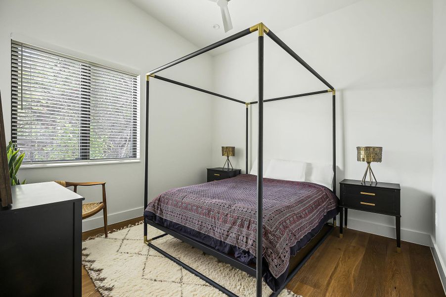 The guest suite has a walk-in closet, high ceilings and sits just outside the kitchen area with separate full bath that includes a shower.