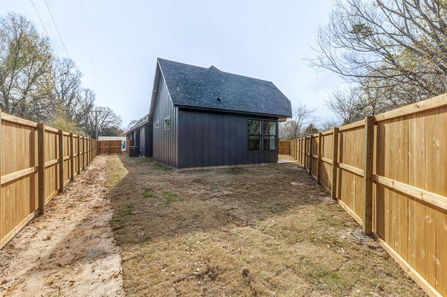 Rear view of property featuring central AC unit