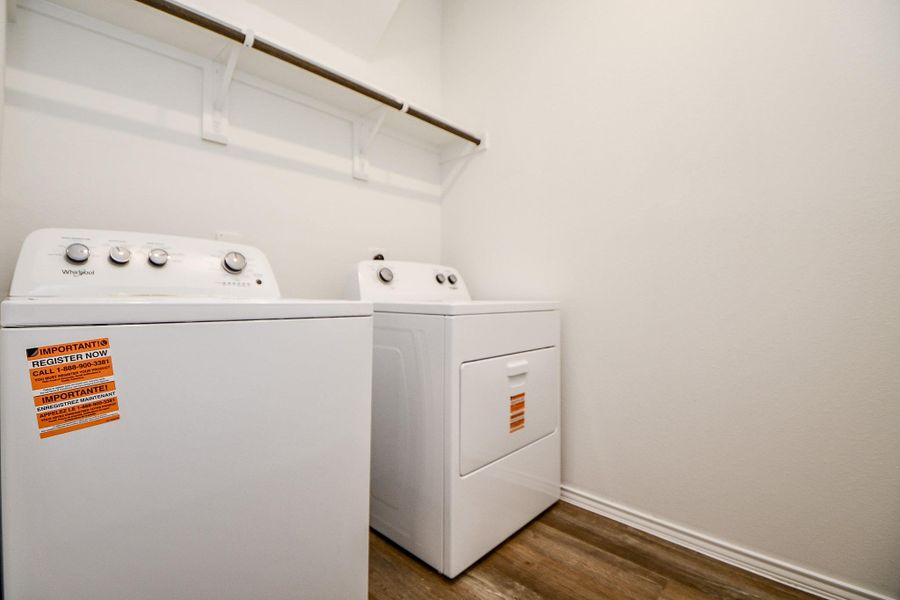 This photo shows a bright, well-organized laundry room featuring a washer and dryer set, with a shelf above for storage. The space has clean lines and a modern feel, offering practicality and convenience for everyday use. This photo shows a bright, well-organized laundry room featuring a washer and dryer set, with a shelf above for storage. The space has clean lines and a modern feel, offering practicality and convenience for everyday use.
