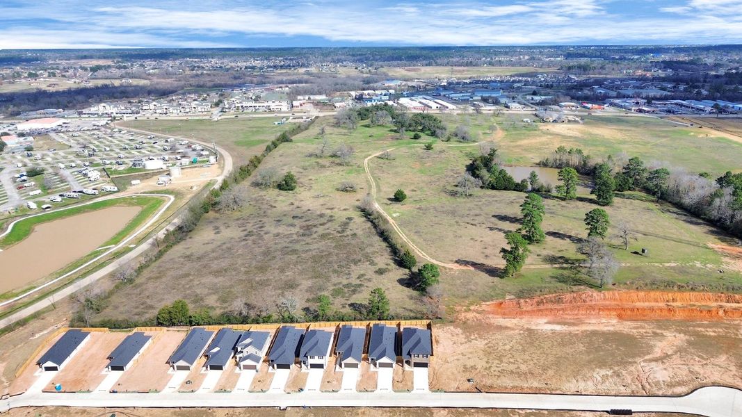 An aerial view of a spacious subdivision lot, highlighting a well-maintained yard and a fully fenced perimeter, offering both privacy and expansive outdoor space. No back yard neighbors. Landscape pending. An aerial view of a spacious subdivision lot, highlighting a well-maintained yard and a fully fenced perimeter, offering both privacy and expansive outdoor space. No back yard neighbors. Landscape pending.