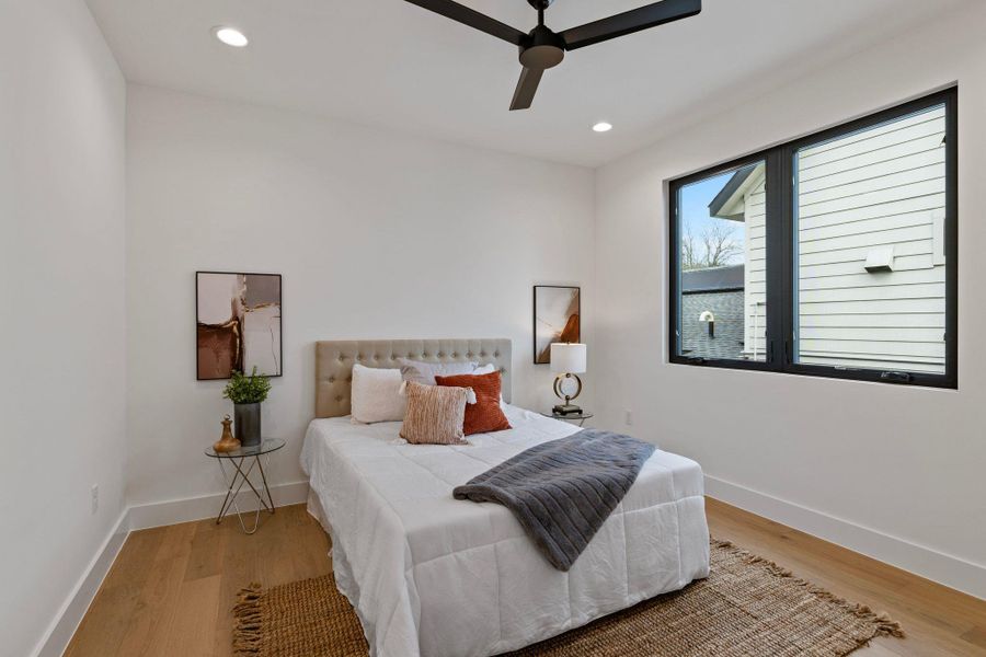 Bedroom with wood finished floors, baseboards, recessed lighting, and ceiling fan