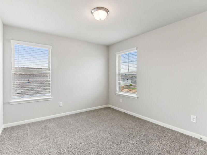 Guest bedroom in the Matador floorplan at a Meritage Homes community.