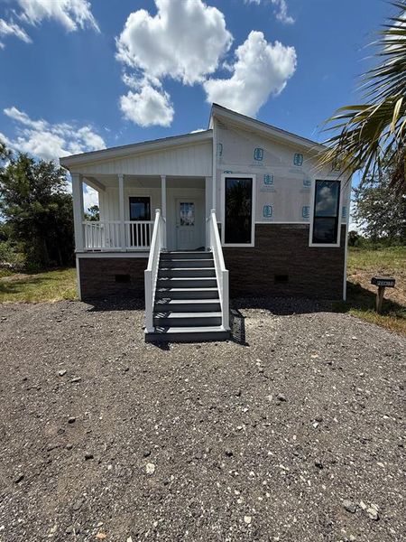 Front exterior of a new home in , Punta Gorda, FL, highlighting curb appeal (Image 1). Front exterior of a new home in , Punta Gorda, FL, highlighting curb appeal (Image 1).