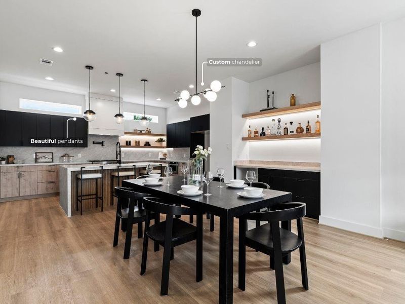 The dining room offers a clean, modern look with views into the kitchen, featuring stylish two-tone European cabinetry.