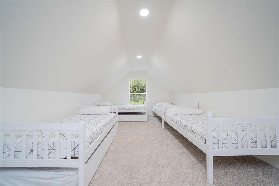 Bedroom with recessed lighting, carpet floors, and lofted ceiling Bedroom with recessed lighting, carpet floors, and lofted ceiling
