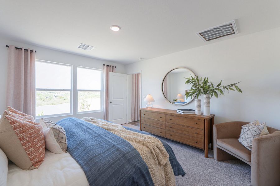 A bedroom with a bed and a mirror. A bedroom with a bed and a mirror.