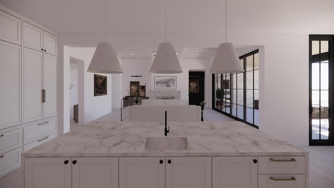 Kitchen with a center island with sink, open floor plan, a sink, and decorative light fixtures