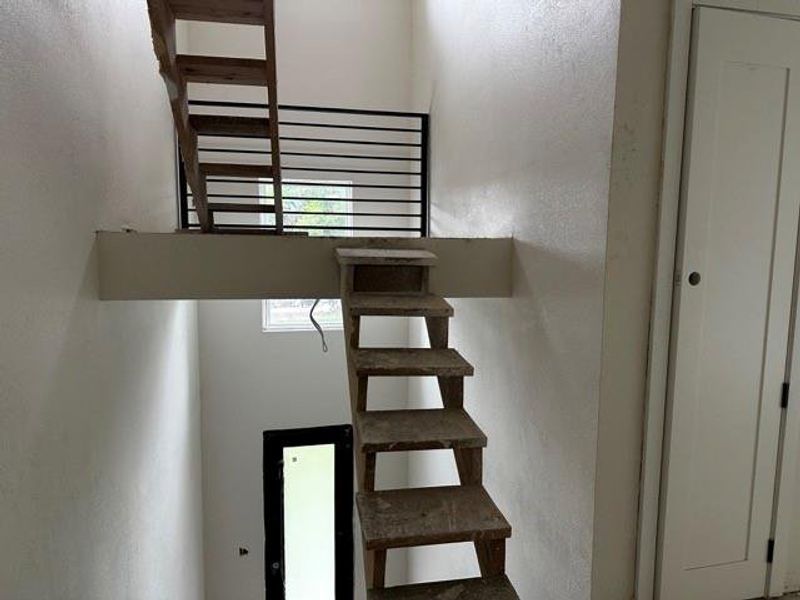 Stairway featuring a textured wall