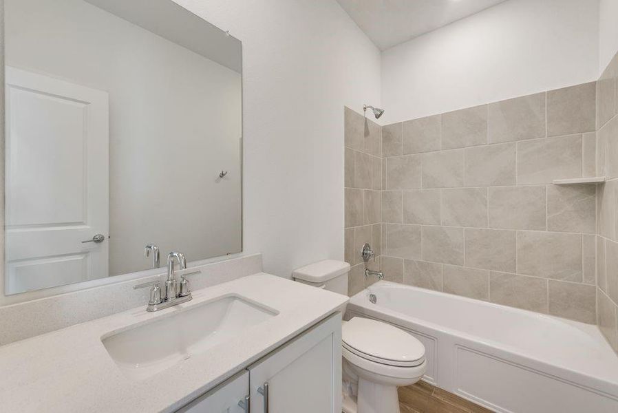 Bathroom with vanity, tub / shower combination, and wood finished floors