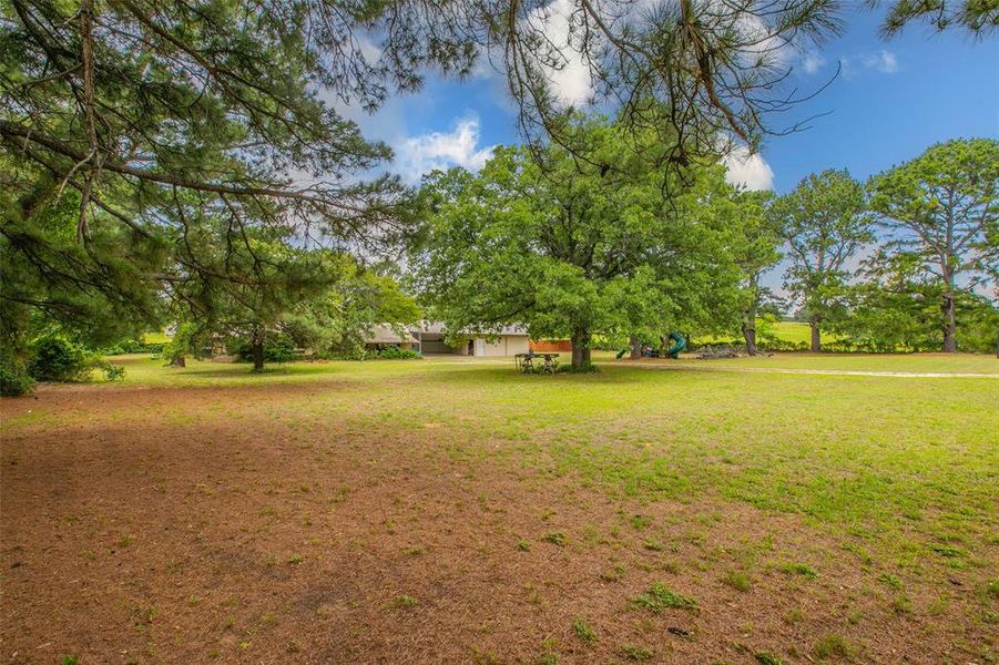 Enjoy approximately 1.5 acres shaded by mature trees with plenty of room to roam, play, or relax Enjoy approximately 1.5 acres shaded by mature trees with plenty of room to roam, play, or relax