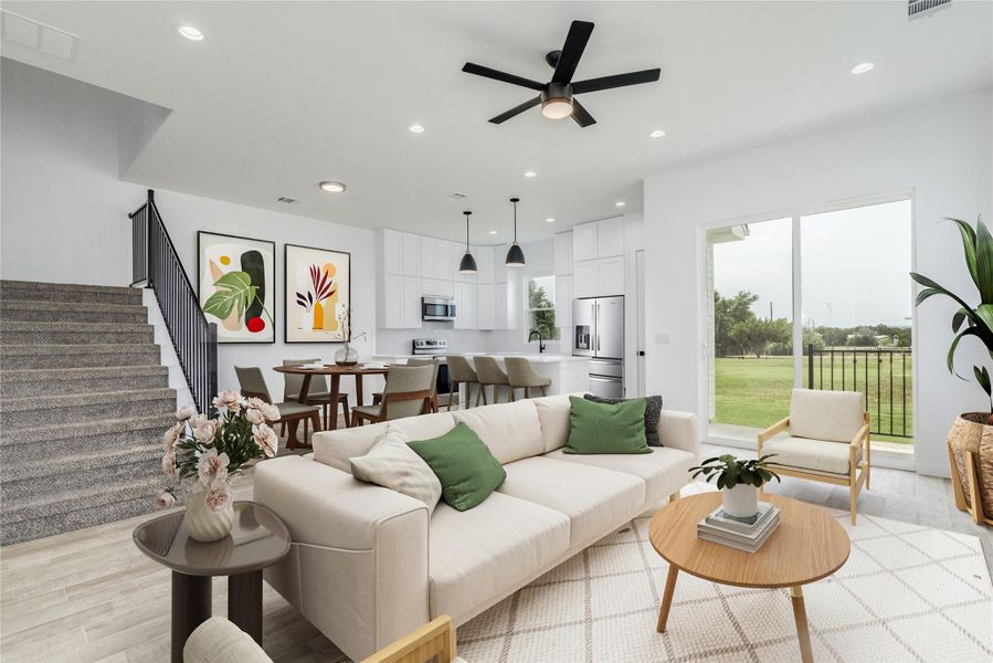 An open concept living area features a bright kitchen and dining space with seamless outdoor access. An open concept living area features a bright kitchen and dining space with seamless outdoor access.