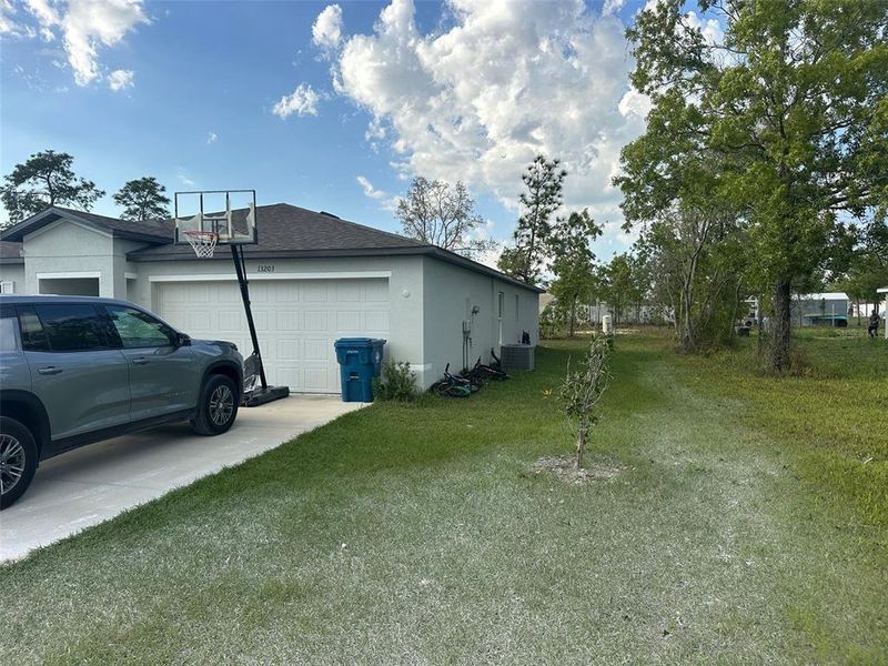 Front exterior of a new home in Spring Hill Classic, Weeki Wachee, FL, highlighting curb appeal (Image 20).