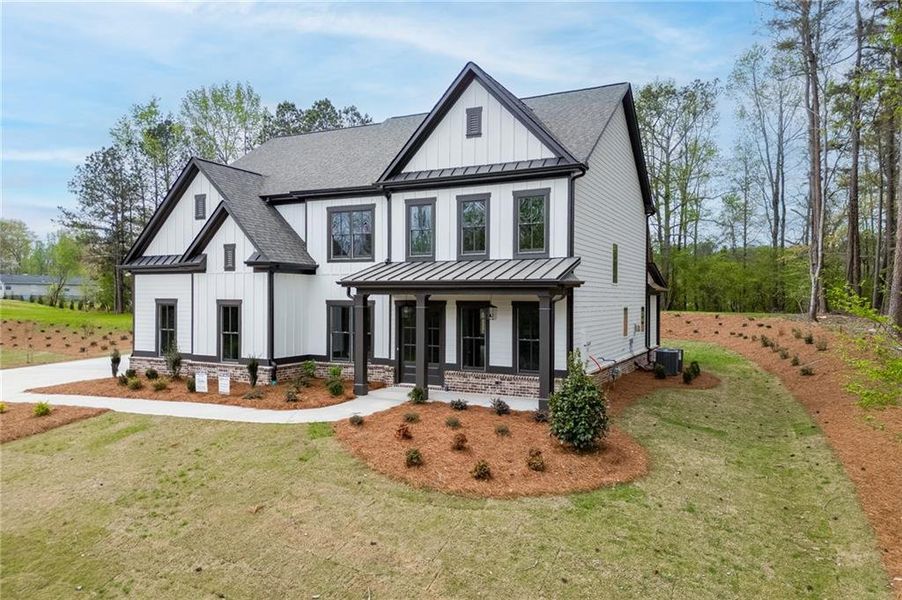 Front exterior of a new home in , Cumming, GA, highlighting curb appeal (Image 1). Front exterior of a new home in , Cumming, GA, highlighting curb appeal (Image 1).